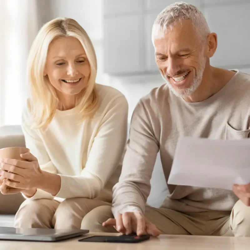 Casal sorrindo fazendo planejando financeiro